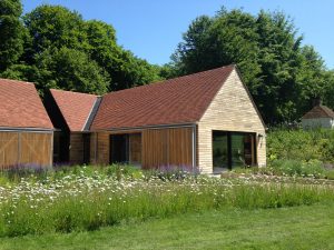 view of a museum building with its pitched roof completed in red tiles by Kingsley Roofing