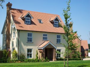 The main roof and dormers on this property were recently completed in plain red tiles.