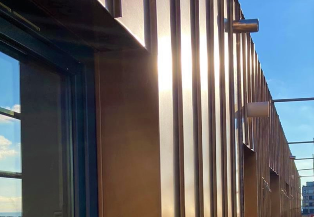 Copper coloured cladding on a block of flats